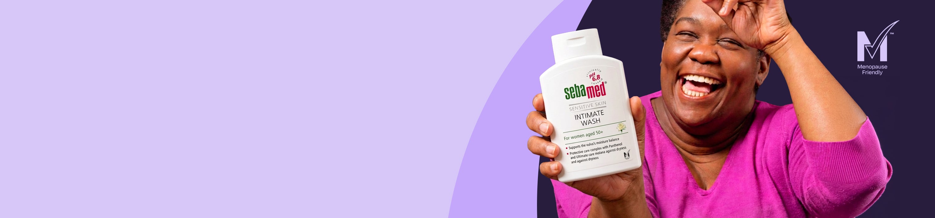 A smiling woman in a bright pink top holds up a white bottle of Sebamed Intimate Wash against a split purple and dark background.