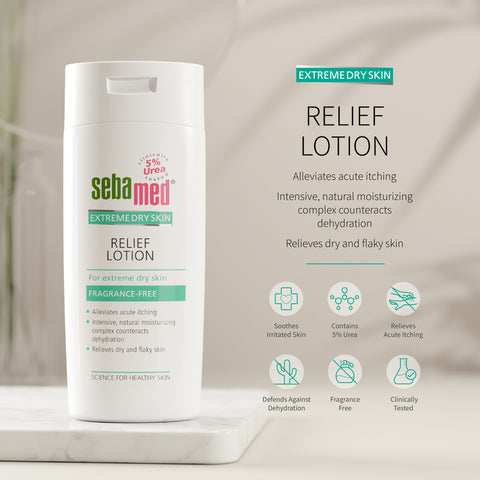 Sebamed Extreme Dry Skin Relief Lotion shown in a white bottle on a marble pedestal with product text and benefit icons on a soft beige background. 