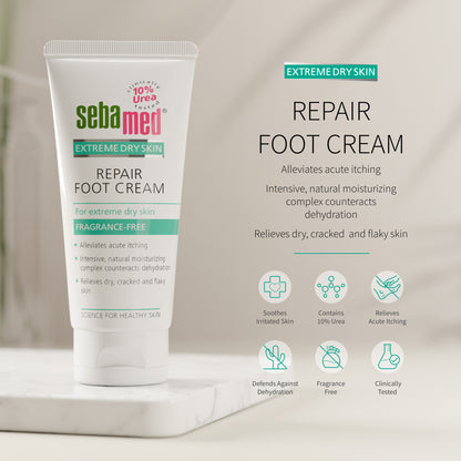 Sebamed Extreme Dry Sin Repair Foot Cream shown in a white squeeze tube on a marble pedestal with product text and benefit icons on a soft beige background.